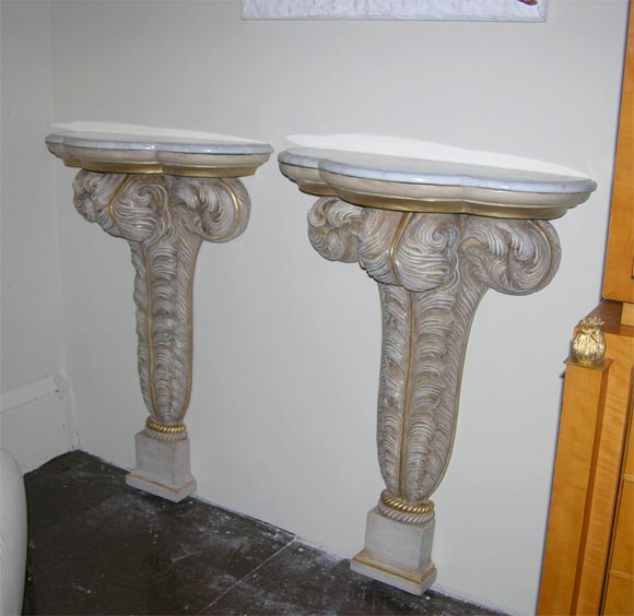 Pair of wall-mounted plaster console tables with feather-form bases and marble tops. By Maison Jansen, France 1940s.

39