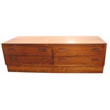 Low and long Rosewood cabinet with drawers.