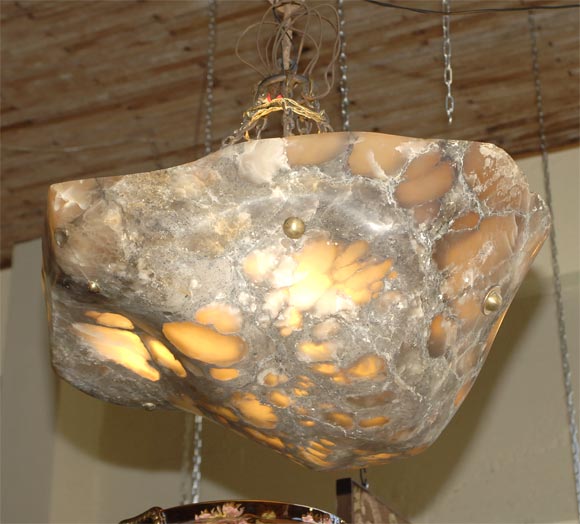 Handcarved from a solid rock of alabaster by a local Bay Area artisan.  This fixture is totally  unique in form and color.<br />
It is wired and ready for use.  The photos do not do this piece justice.  The colors are richer and deeper and the