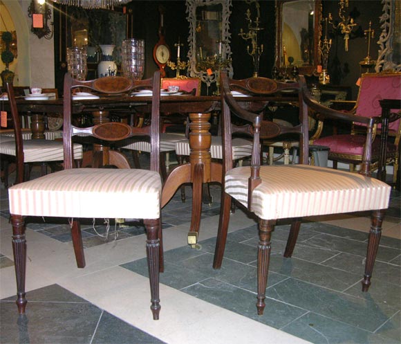 Set of eight Regency mahogany dining chairs with receded supports and inlaid burl tablet splats. Two-arm, six side.
