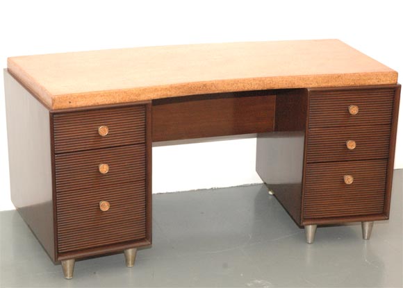 Rare Paul Frankl desk with cork top and believed to be custom built.  Desk has a graceful slight curve to it and is beautifully refinished in french polish.  Front drawers and back have combed wood detail.  Also, small open bookshelf on backside of
