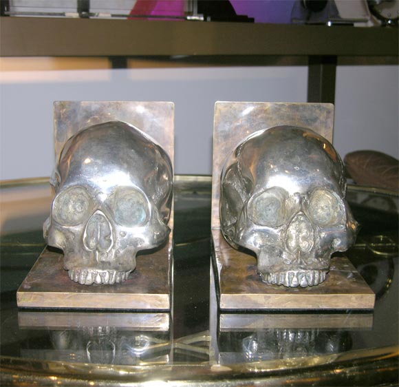 Life size, silverplated bronze skulls on brass bases.