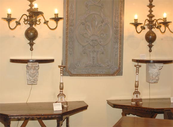 Pair of carved marble corbels with walnut tops