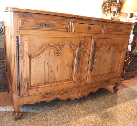 18th century, 2 door, 3 drawer hand carved merisier buffet.

Not the original finish. The surface has been bleached to give the buffet its present blond color.