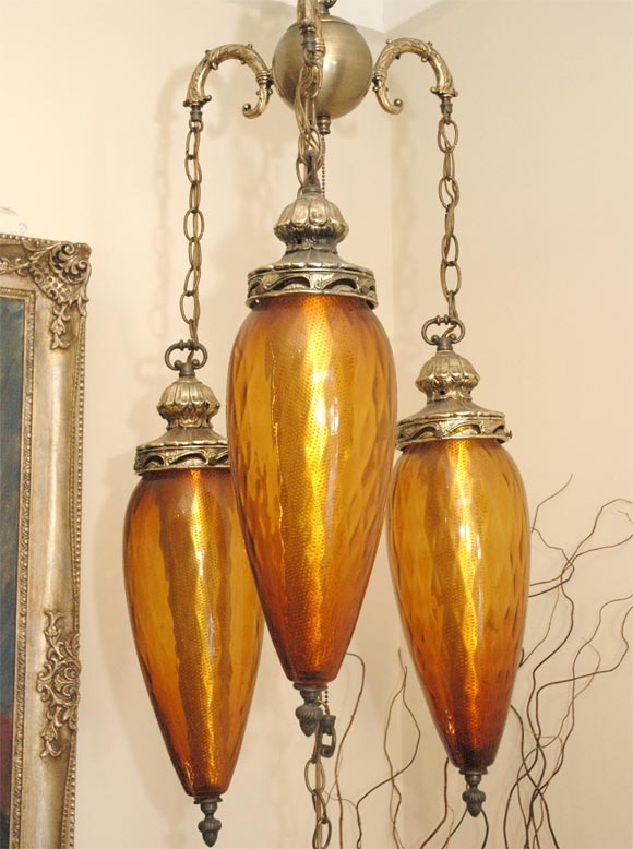Stylized Amber Glass 3 tier, tear drop chandelier with detailed top and pull. 12' of original chain is available to use as a swag lamp.