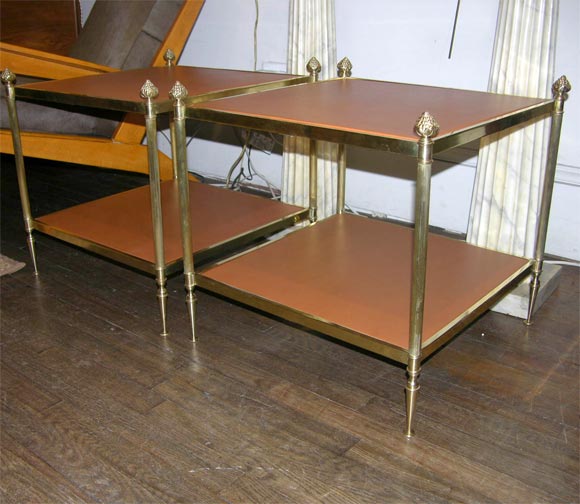 A pair of two tier brass and leather sofa end tables, round fluted tapering legs, French, circa 1940.