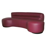 Red leather kidney shaped sofa