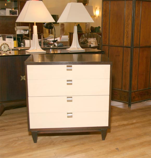 Diminutive chest with Wenge finish on case and translucent white- drawer fronts.and nickel pulls. Produced by American of Martinsville, circa 1955