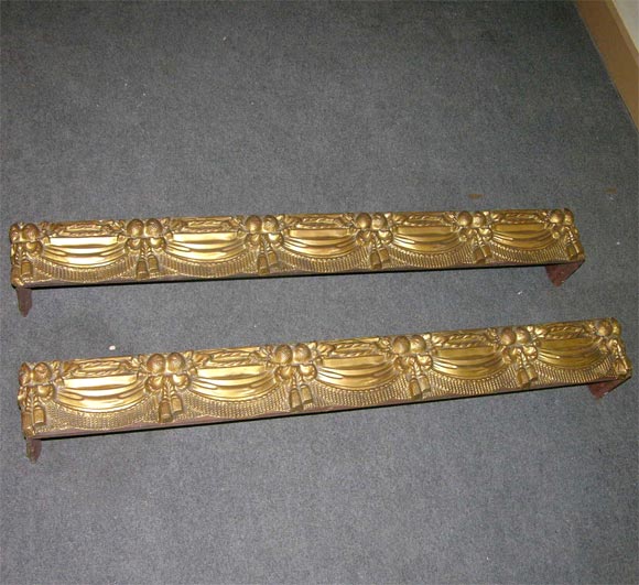 Wood and detailed brass valance.