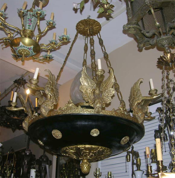 A baronial 8-arm Empire-style chandelier with original paint.  This fixture also features an interiorly lit large 
