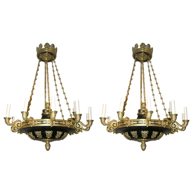 A pair of circa 1940's French gilt and painted bronze Empire-style chandelier with 12 lights each, foliage motif decoration on body, original chain and canopy. Sold individually.

Measurements:
Diameter: 30.5