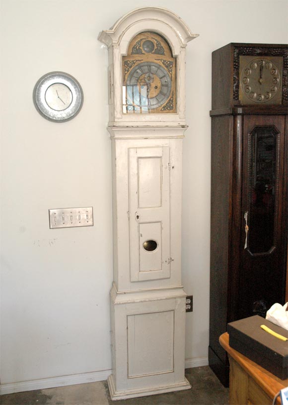 Like all older creatures this longcase clock has undoubtably lived a varied and wonderfully interesting life. Who knows how long the clock works and case have lived together, one may only guess. Resting behind the glazed upper door is an arched dial