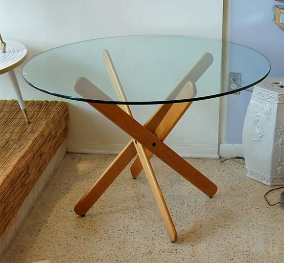 Fun 70's oak table by Dan Droz folds down into a stack of what can only be described as over-sized popsicle sticks! The 28 in. diameter base is topped with a 42 in. diameter piece of half-inch glass.
