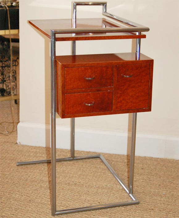 Eileen Gray designed this petite coiffeuse for her summer house E1027 in 1929. Chrome plated tubular steel frame with table top and suspended box comprised of two swivel out drawers and a door. Original lacquer finish and chrome pulls.<br