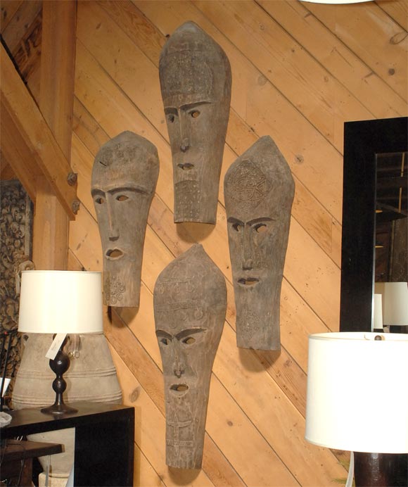 Tribal Masks from Timor Island with various tribal motifs carved on the mask surfaces.