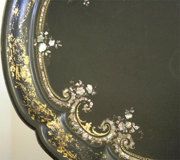Papier mache tray, with scalloped and formed edges; decoration is quite intricate with mother of pearl floral design and gilt edging