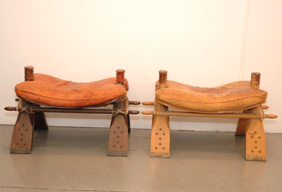 Great character and patina to these leather and wood stools with brass stud detail.