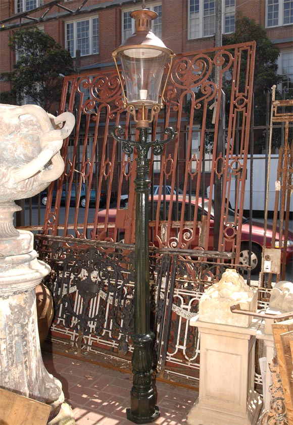 UNUSUAL AND WELLMADE VICTORIAN STYLE COPPER AND PAINTED IRONLANTERNS,EACH OCTAGONAL AND LEAF MOLDED STANDARD SUPPORTING A TAPERING LAMP WITH PAGODA FORM PIERCED FLUE SURMOUNTED BY A SPIRE FINIAL. THESE CAN BE PURCHASED INDIVIDUALLY.
