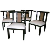 Set of four polished black slipper chairs