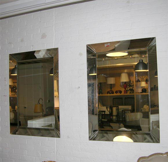 One vertical wall mirror with lightly antiqued beveled border, mirrored corner mounts and clear mirror field.  Priced individually.