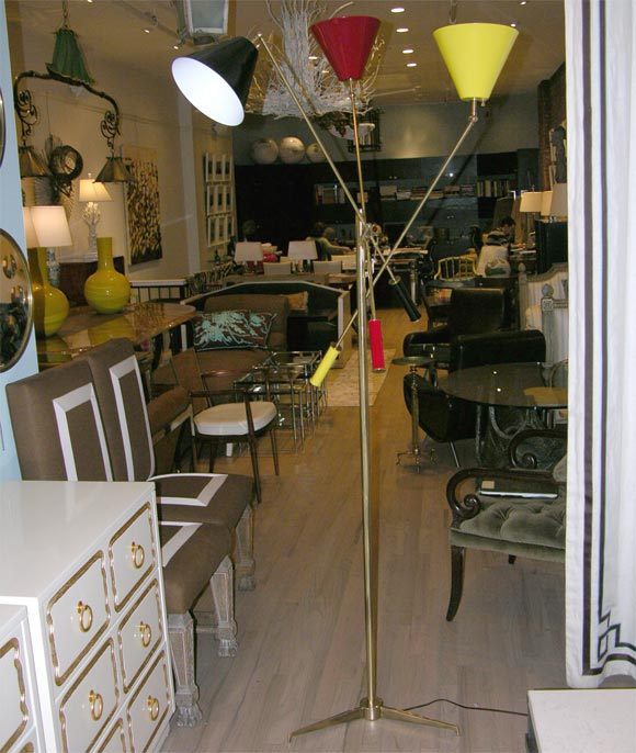 Iconic floor lamps by Arredoluce, the Trienale needs no presentation. this is an early matched pair in brass with the  tripod base. each light can be turned on independantly. sold as a single or pair. price is for one.