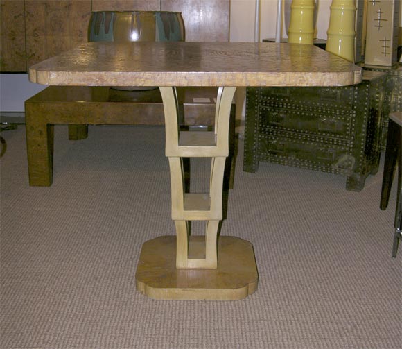 A game / center table in a curly burl oak veneer with an inverted ladder form pedestal base. By Johan Tapp. U.S.A., circa 1940.