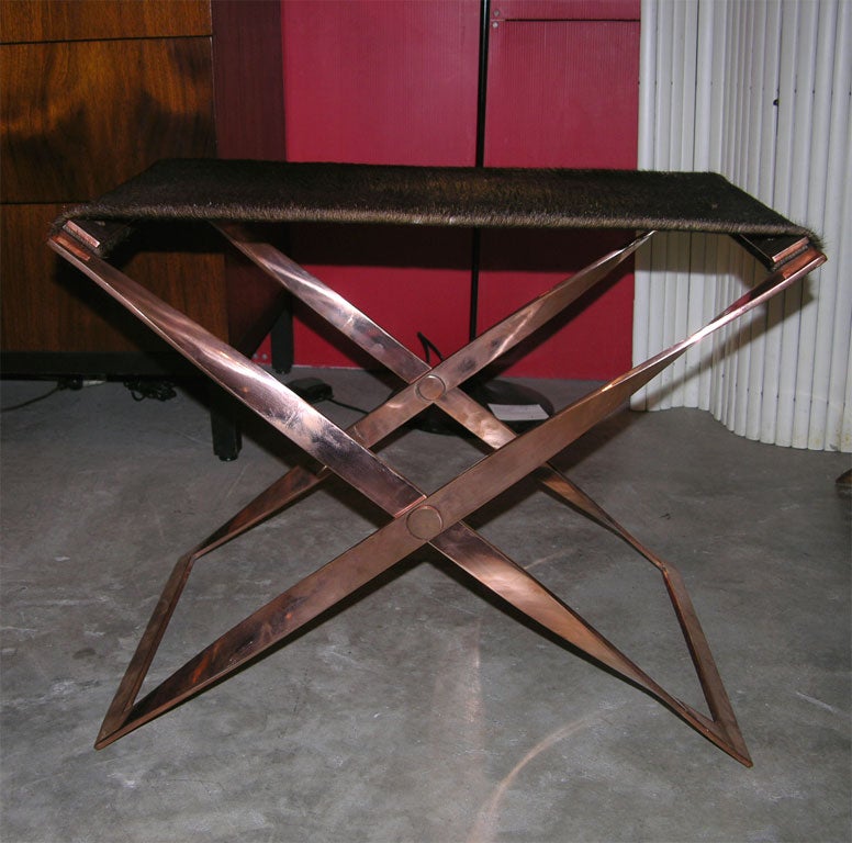 Pair of copper plated folding stools with cow hide slings