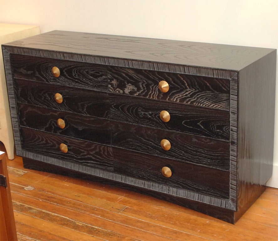 Paul Frankl design for Brown Saltman made from oak with a limed black lacquer finish with polished brass pulls.