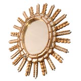 Oval starburst mirror in the style of Line Vautrin