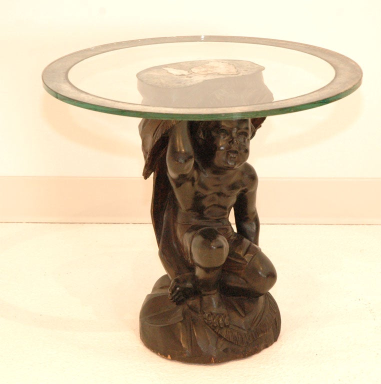 A Glass and Mirrored Top Table with Carved Wood Cherub Base