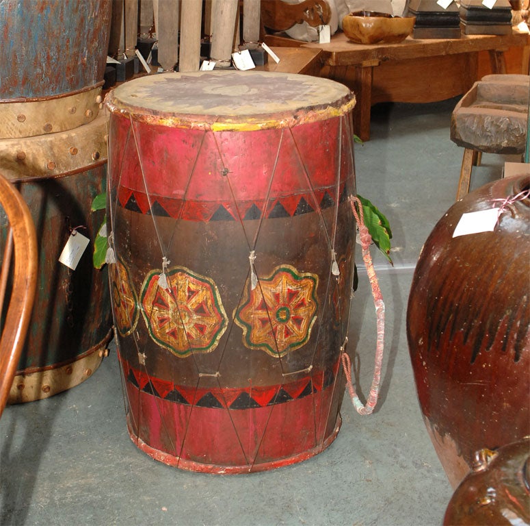 Original paint and finish on an old ceremonial drum from Lombok Island. Skin drum top and gut stretchers. Flower motif hand decorated in a primitive manner with native folk art references.