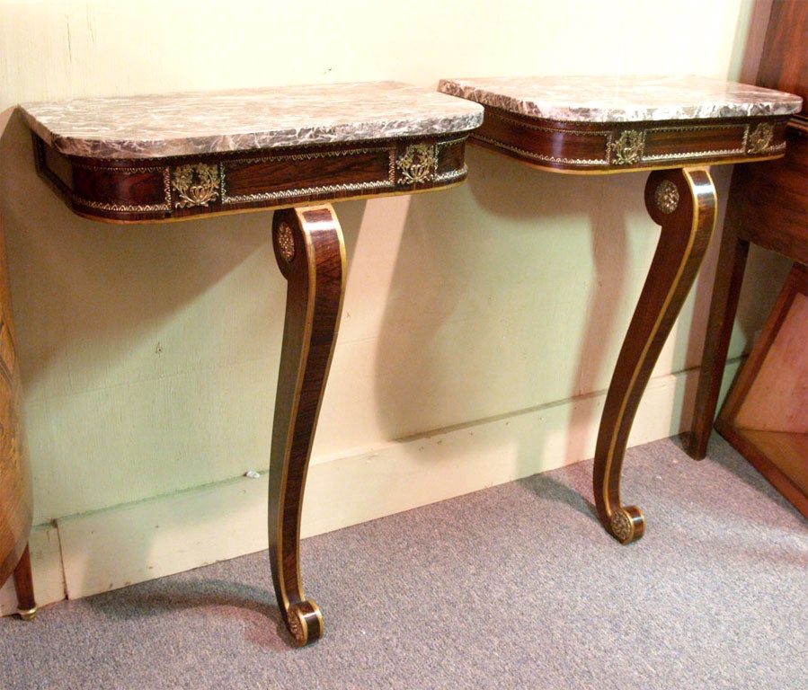 Pair of antique Engish rosewood consoles.  Regency.  Marble tops.