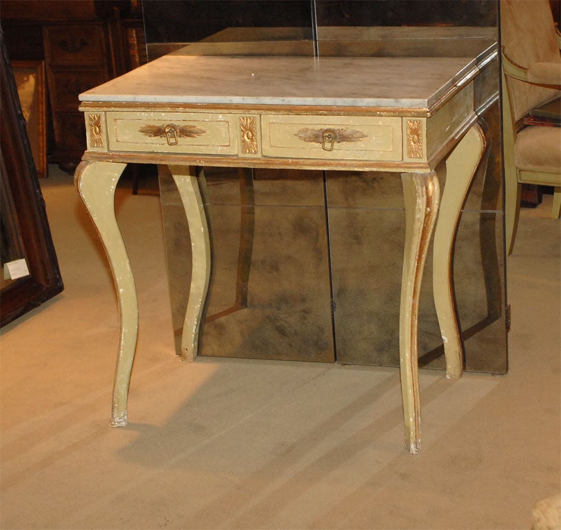 A late 19th century, Italian two-drawer painted and giltwood console with a marble top.