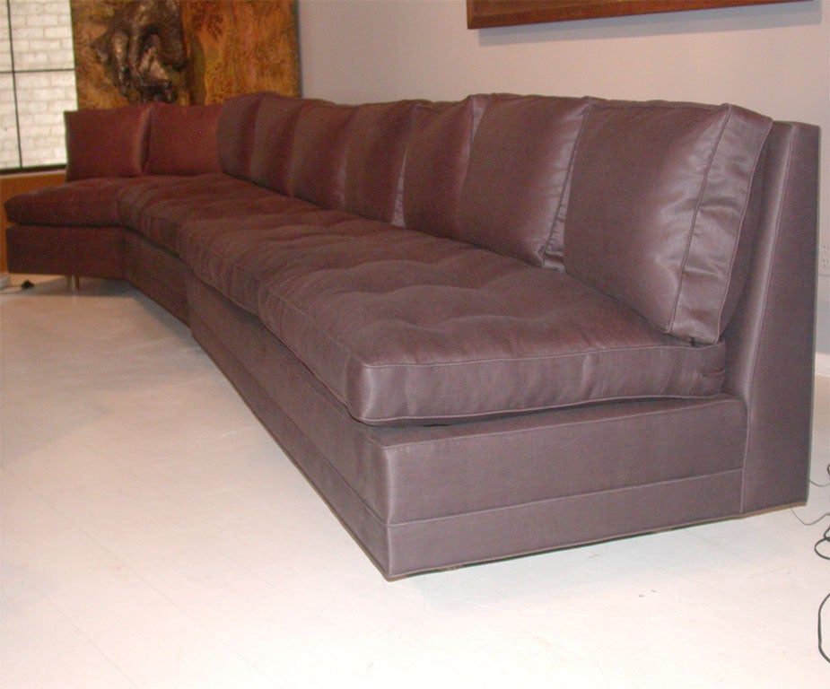 Two Piece Armless Sectional Sofa.  Completely Re-made.  Nine New Down Filled Back Pillows.  New Button Tufted seat Cushions.  Covered in Linen Sateen.  Sits on Ten Round Wooden Legs.  The sofa may be configured to an open angle sectional.