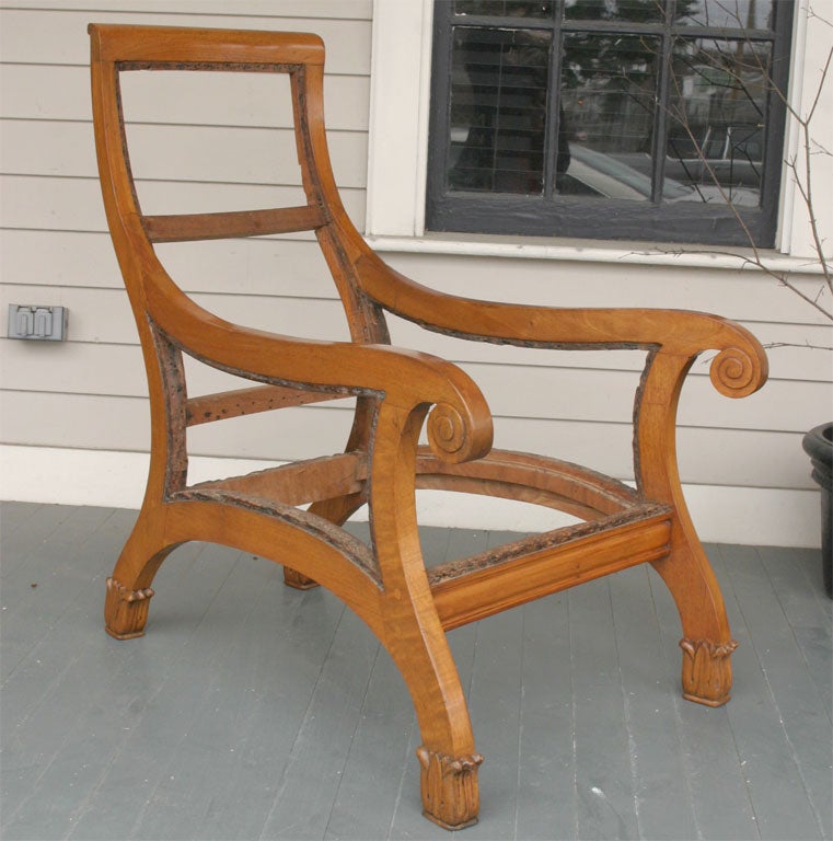 A very unusual mahogany chair in light stain with an almost sleigh-like feel. The height of the back and depth of the sides make a dramatic impact when upholstered.