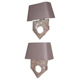 A pair of metal shield sconces