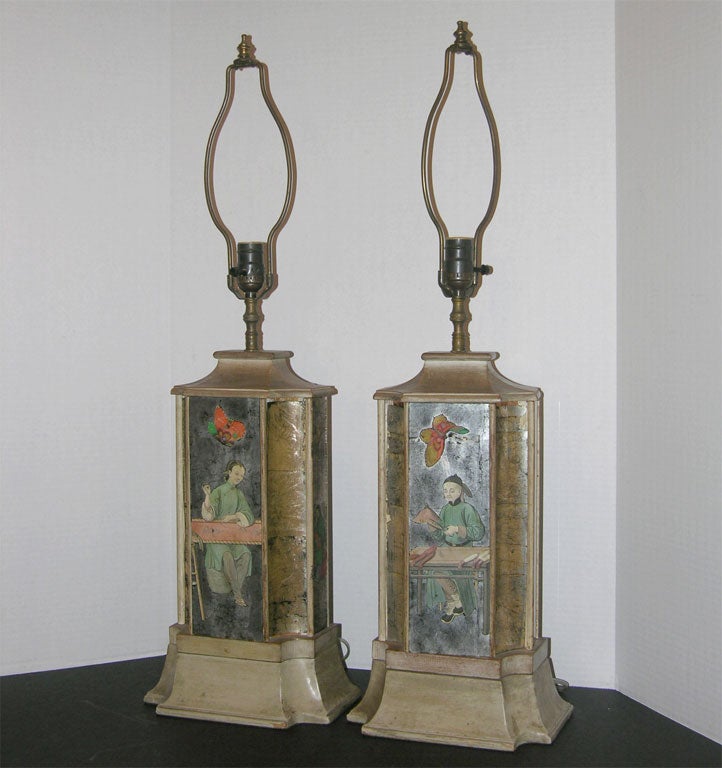 Pair of decoupage and silver leaf lamps with the motif of a Chinese haberdasher and embroiderer set in a limed wood frame.  This pair of lamps are 22