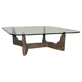 Large scale iron base cocktail table with glass top.