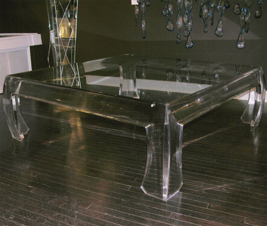 Lucite cocktail table with glass top.