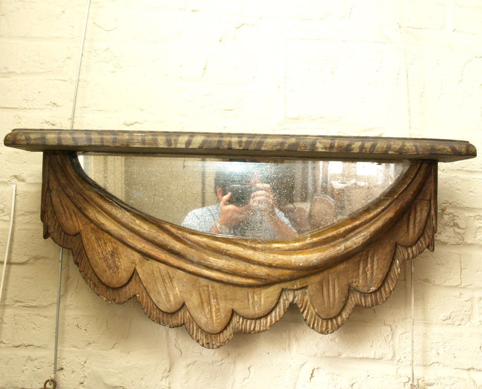 A pair of brackets with carved and giltwood swags, original mirrors and faux marbre wood tops, 19th century, Italian.