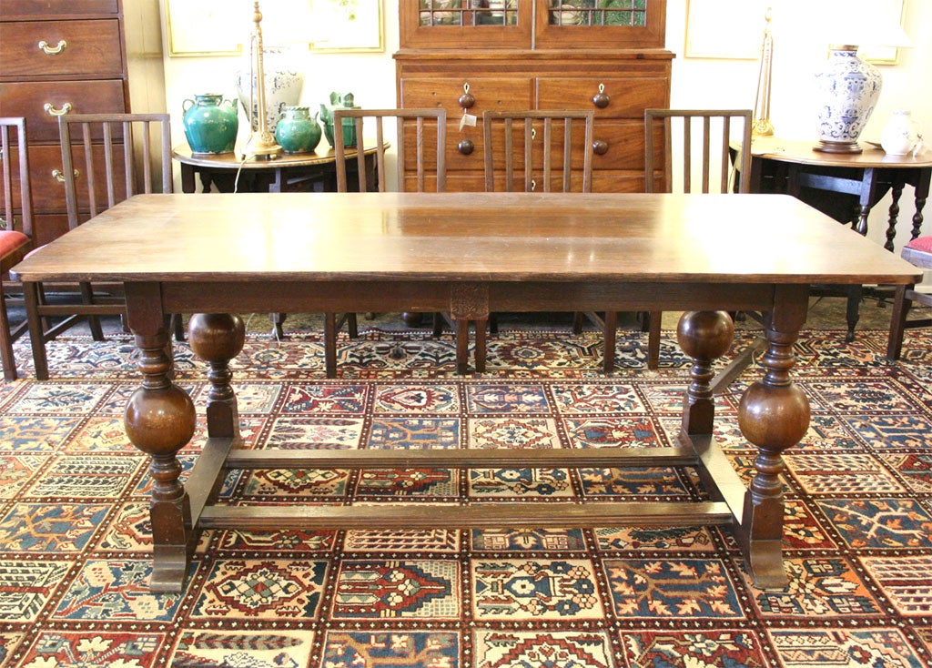 Oak table with bulbous turned legs; shaped stretchers and low foot rests