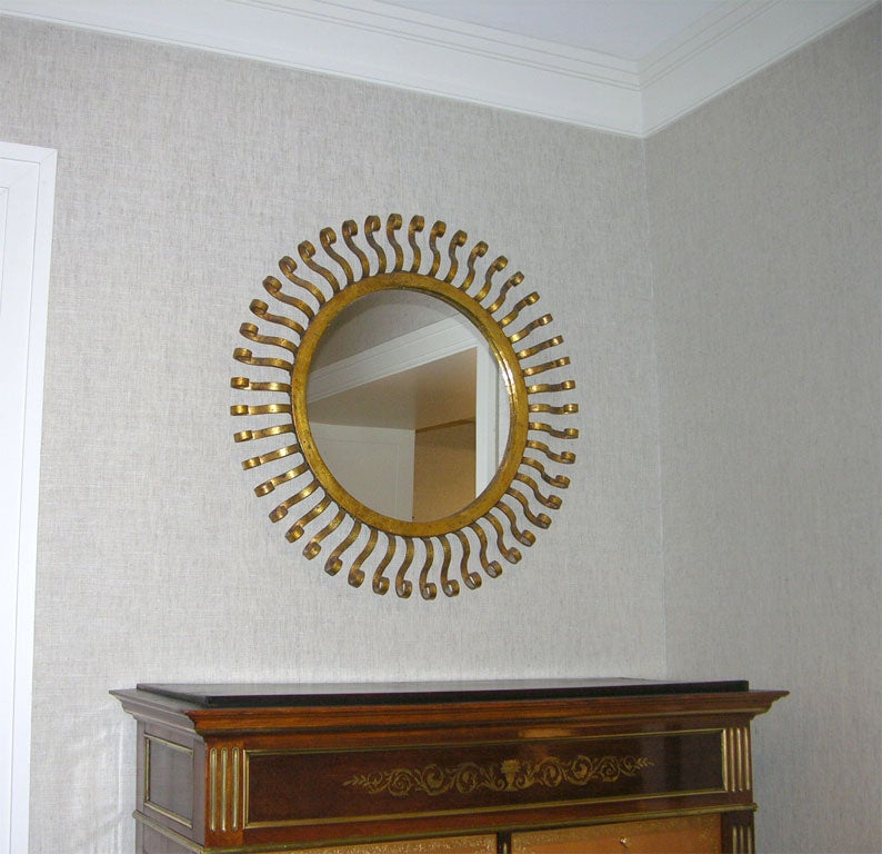 Unusual Spanish Gilt Metal Sunburst Mirror,  Mid 20th Century <br />
<br />
25 inches diameter