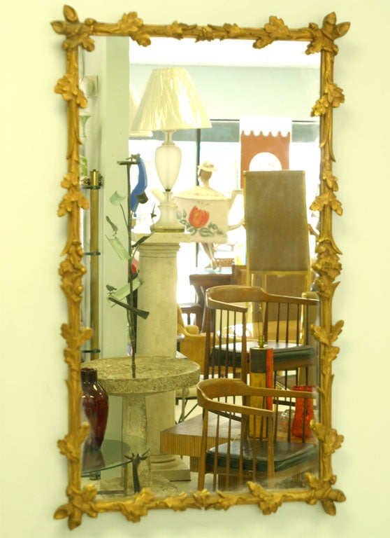 Pair of highly decorative matched pair of mirrors with an intricate tree branch motif.