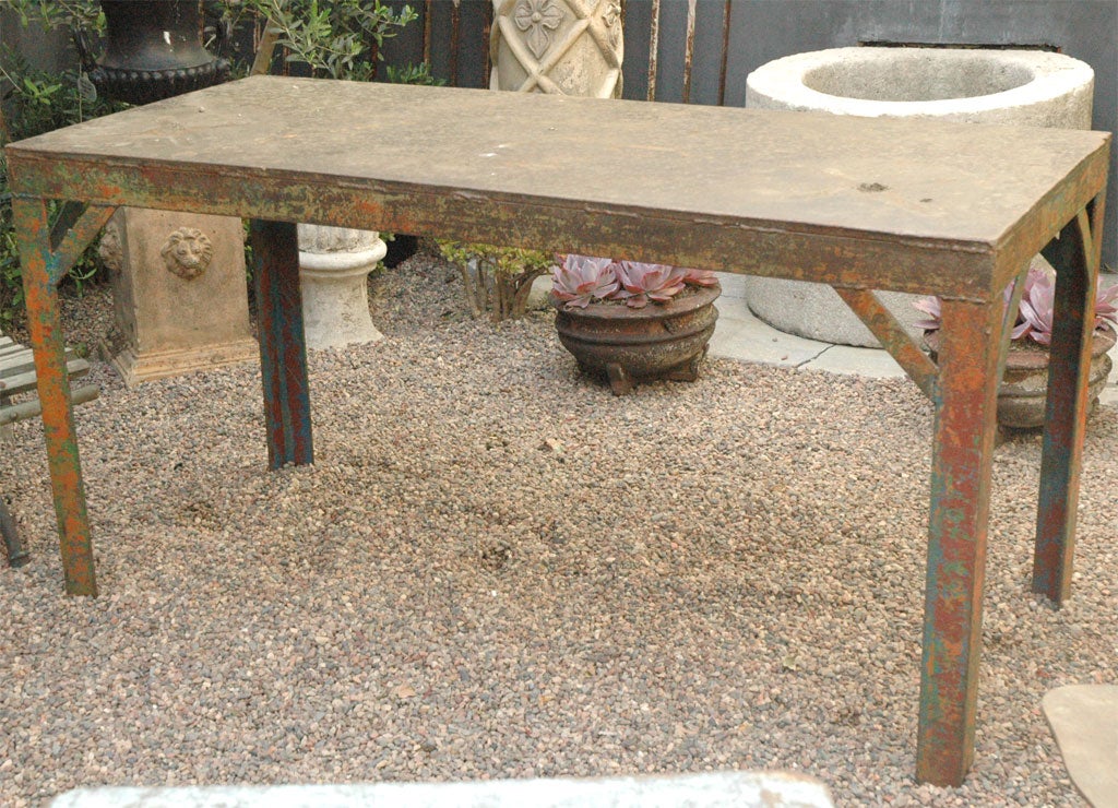 A fabulous rectangular iron table with straight legs and remaining colored paint. Can be used as an outdoor garden table, dining table or occasional table.