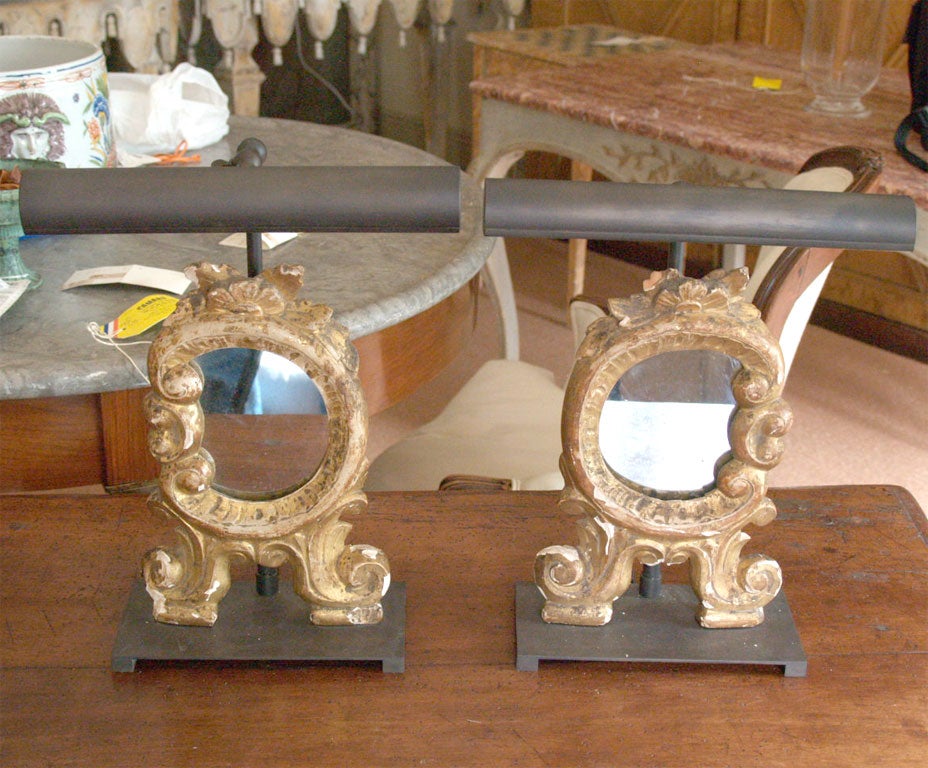 Miniature Louis XV mirrors are mounted on bronze bases and fitted with bronze picture lights.