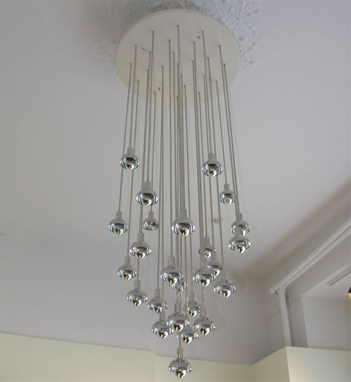 Dazzling 25-arm ceiling chandelier. Shiny silver caps finish off the branches of this futuristic fixture. It is in the style of Verner Panton.