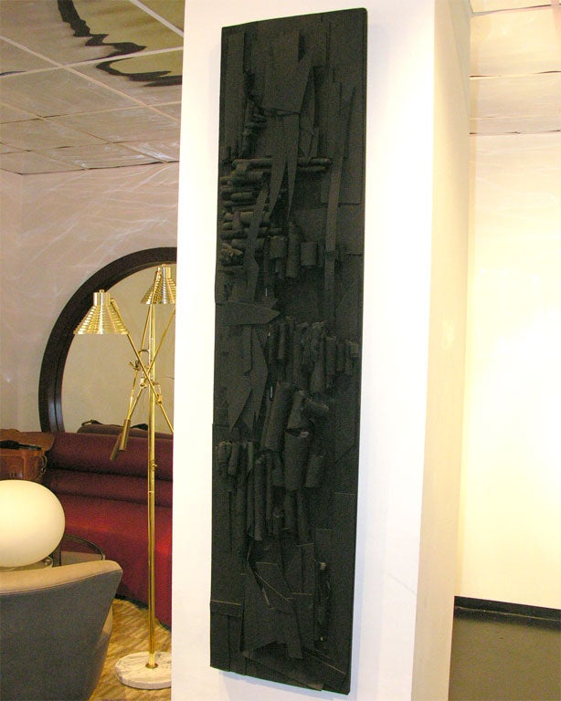 Intricate abstract-Expressionist relief wall sculpture, an assemblage of paper and wood elements in varied treatments and forms which are layered onto a board mounting. Painted flat black. Beautiful and unique on its own, it can't help but remind
