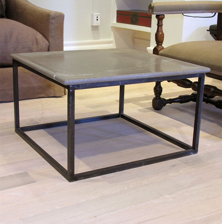 Custom-made table with Piasentina stone and a solid steel base with hand-blackened patina.
