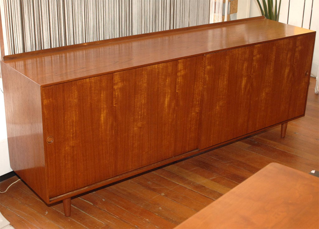 Elegant Finn Juhl design buffet for Baker furniture co. Danish modern style made from solid teak with high quality construction and attention to detail. Completely restored. Originally $6800.00 Net price $4800.00