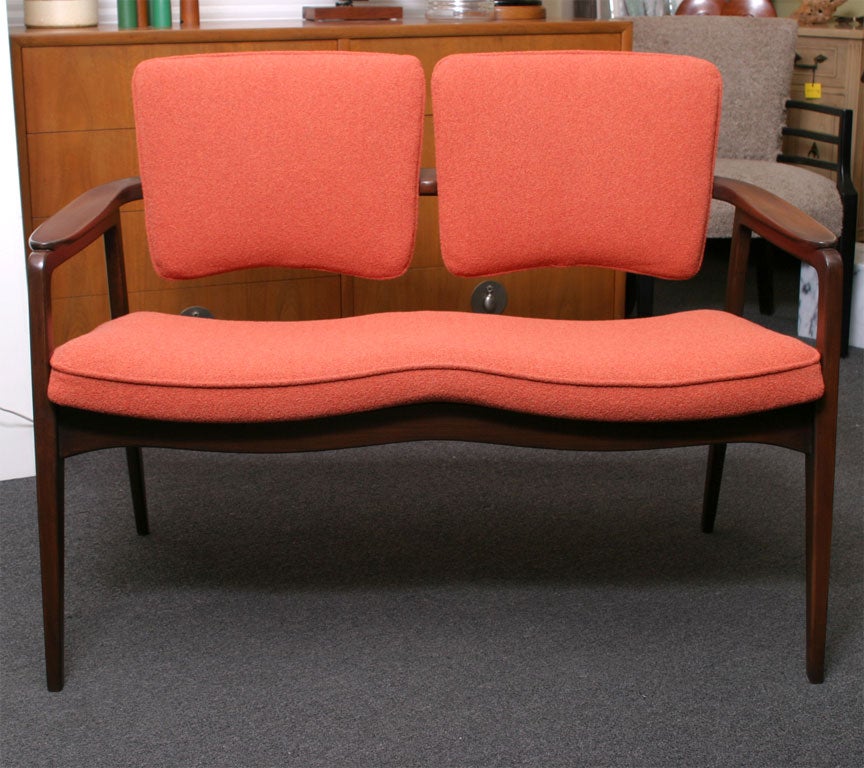 Fine two seater bench designed by Count Sigvard Bernadotte (his father, King of Sweden) for France & Daverkosen and imported from Denmark by John Stuart, 1955.  Freshly polished and reupholstered in a boucle knit fabric.  The back cushions with
